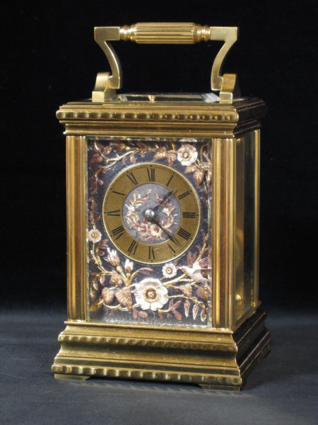 Carriage clock with a dial in multicoloured relief work 