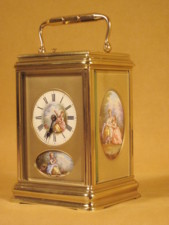 rare strike and repeat carriage clock with oval porcelain panels.