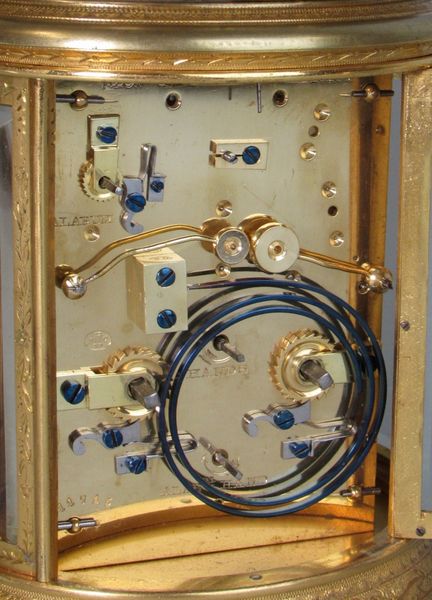 An engraved oval carriage clock