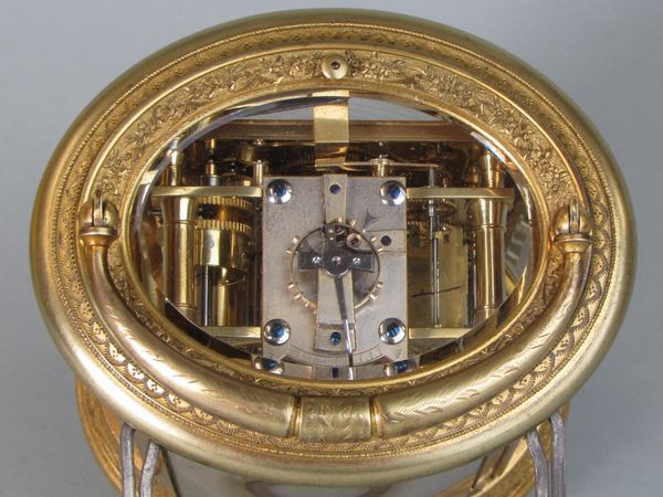 An engraved oval carriage clock