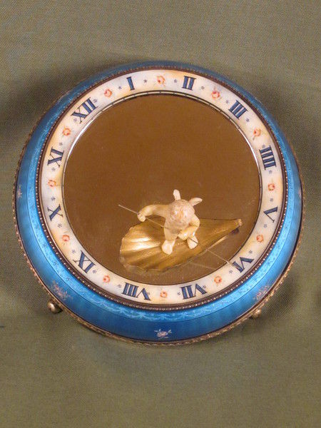 Silver and enamel novelty clock with rotating figure to show the time.    