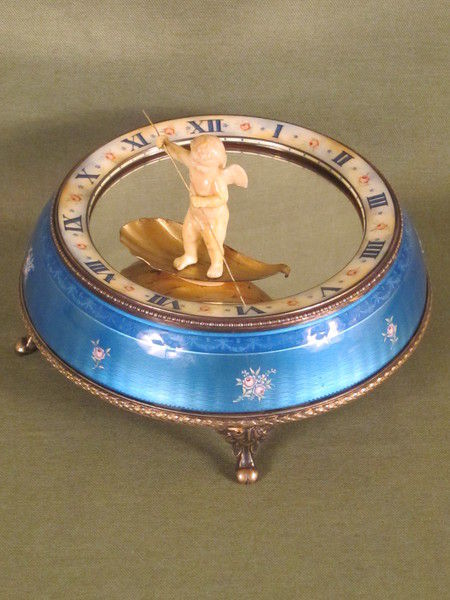 Silver and enamel novelty clock with rotating figure to show the time.    