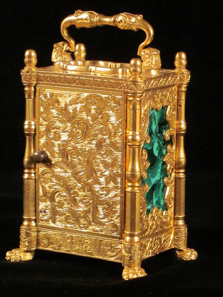 miniature engraved carriage clock on stand with malachite panels.