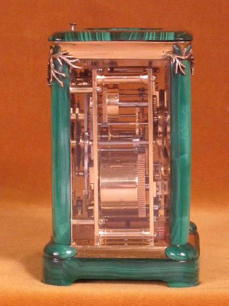 A French carriage clock almost completely covered with solid malachite
