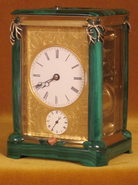 A French carriage clock almost completely covered with solid malachite