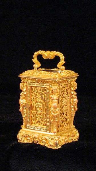 Miniature carriage clock with carytids, engraved panels and original case.  