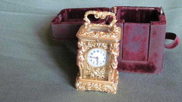 Miniature carriage clock with carytids, engraved panels and original case.  