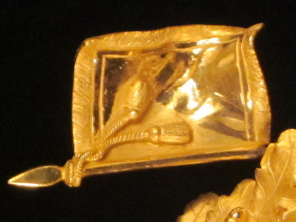 A fine fire-gilt mantel clock featuring a roman soldier and weapons.