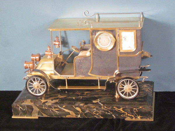 A rare automaton car clock by Guilmet, 
