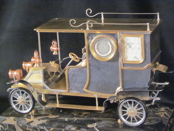 A rare automaton car clock by Guilmet, 