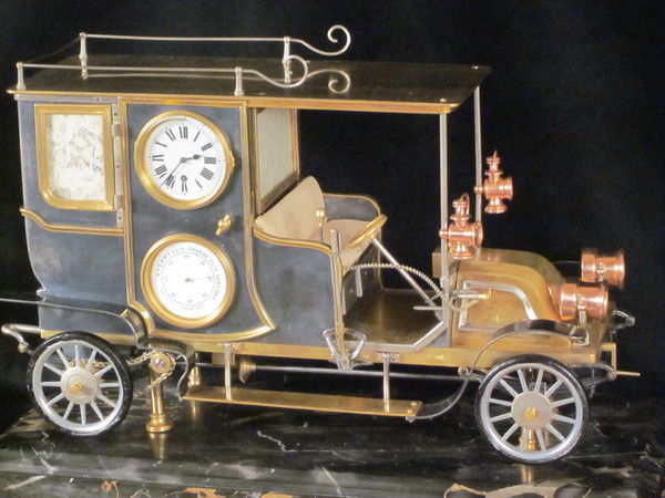 A rare automaton car clock by Guilmet, 
