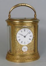 An engraved oval carriage clock