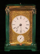 A French carriage clock almost completely covered with solid malachite