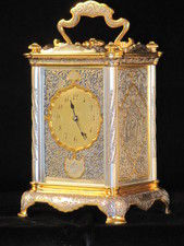 The Basilisk carriage clock, with very finely decorated metal panels.