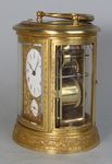 An engraved oval carriage clock (Paris)