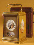 rare strike and repeat carriage clock with oval porcelain panels.  (France)