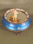 Silver and enamel novelty clock with rotating figure to show the time.     (Switzerland)