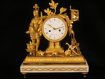 A fine fire-gilt mantel clock featuring a roman soldier and weapons. (France)
