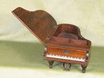 Miniature rosewood necessaire in form of a grande piano, with music box (England)